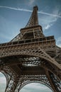 Bottom view of Eiffel Tower made in iron and Art Nouveau style, with sunny blue sky in Paris. Royalty Free Stock Photo